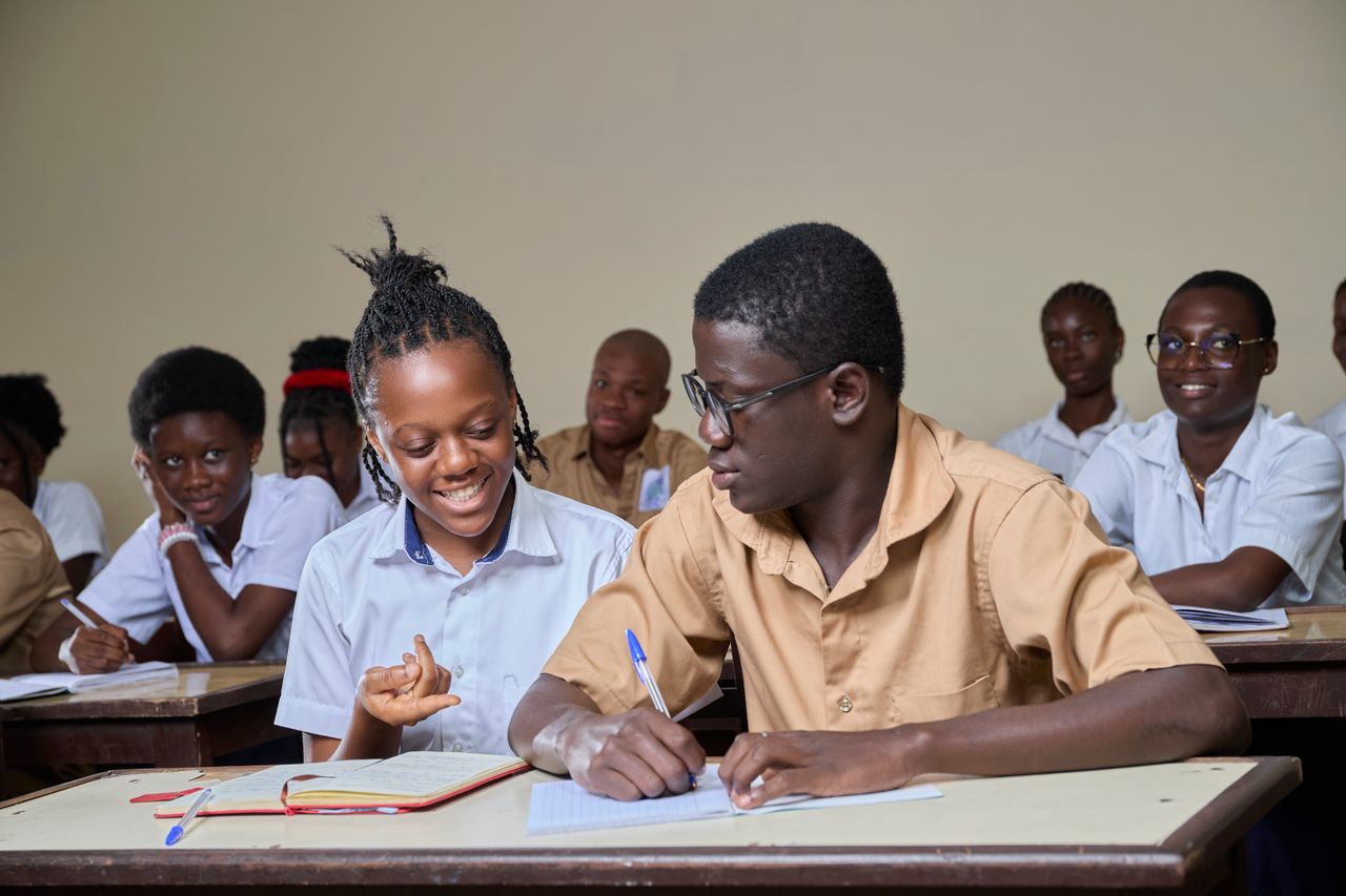 High school students collaborating during a lesson in a classroom environment.
